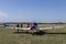 Unidentified people visit small sports planes at the aviation rally, Stanesti aerodrome, Gorj, Romania