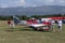 Unidentified people visit small sports planes at the aviation rally, Stanesti aerodrome, Gorj, Romania