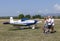 Unidentified people visit small sports planes at the aviation rally, Stanesti aerodrome, Gorj, Romania