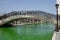 Unidentified People walking by the Green Dyed Canal and some standing on the bridge at St Patrick\\\'s Day in Indianapolis, IN