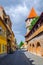 Unidentified people wander along the medieval defense wall and The Carpenters' Tower in Sibiu city, Transylvania