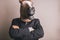 Unidentified person with a dark grey suit and tie wearing a horse mask crossing arms