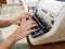 Unidentified personâ€™s hand typing on retro typing machine