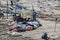 Unidentified poor local Traditional fisherman are living on the beach in the middle of the garbage and cows and goats, under tents