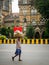 Unidentified porter wearing covid-19 mask carrying fruits cart at CST station, Mumbai