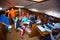 Unidentified sailors on skipper\'s briefing in the yacht wardroom during sailing regatta among Greek island