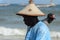 Unidentified Senegalese man in a hat looks down on the coast of