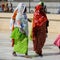 Unidentified Senegalese people in colored traditional clothes w