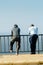 Unidentified Senegalese two men lean on the fence on the coast