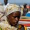 Unidentified Senegalese woman in headscarf looks down on the co