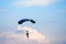 Unidentified skydiver, parachutist on blue sky