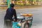 Unidentified street hawker pushing a mobile kitchen cart on a st