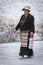 Unidentified tibetan pilgrim praying near the magnificent Potala Palace in Lhasa, home of the Dalai Lama