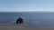 Unidentified tourists around Hvitserkur, a spectacular rock in the sea, Iceland.