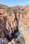 Unidentified tourists on a pedestrian bridge at Bourkes Luck Potholes