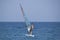 Unidentified Turkish man glides over the waves of the Mediterranean Sea windsurfing