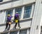 Unidentified Washers Wash The Windows Of Old Building In Central London