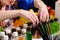 Unidentified woman choosing bottle with liquid at the bar counter