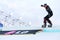 Unidentified woman competitor balances on snowboard