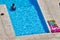 Unidentified woman cools off in a swimming pool on a scorching hot day.