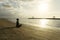 Unidentified woman exercising yoga on the beach