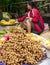 Unidentified woman selling fruits at traditional asian market. Laos