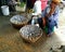 An unidentified Woman sells dried fish on footpath