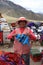 Unidentified Woman sells Wool Hats on Limite Vial. Puno Region. Peru