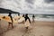 Unidentified women surfers with surfing boards coming to the sea