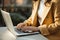 An unidentified young girl in a yellow jacket is typing on a laptop. Generated by AI