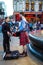 Unidentified young man with a bagpipe in the Scottish national dress at Piccadilly Circus