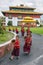 Unidentified young novice buddhist monks in traditional red robes practicing in playing Tibetan music