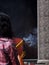 Unidentify buddhism temple visitors praying with large size smoking joss sticks