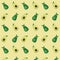 Uniform pattern of two avocado halves on a yellow background