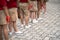 Uniformed children aligned legs standing on school playground