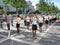 Uniformed Chinese workers exercising in the street at morning.