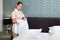 A uniformed maid with white gloves changes the bed linen. The concept of hotel business and cleaning. High-quality service in the