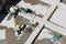 Uniformed workers clean sand on a construction site, top view