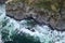 Uninhabited coast in the waters of the Pacific ocean from a bird`s eye view rocks and waves in the elements