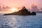 Uninhabited Seychelles island - view from the sea during sunset