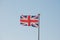 Union Jack British flag flying on a weathered flag pole
