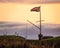 A union jack flag or British flag flying on a flagpole at sunset