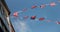 Union Jack flags against on houses a blue sky celebrating the Queenâ€™s Platinum Jubilee in England 2022