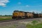 Union Pacific lashup with locomotives 6814 and 5468 smokes and steams westbound with empty coal hoppers