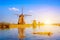 Unique beautiful landscape with windmills in Kinderdijk, Netherlands, Europe against a background of cloudy sky reflection in