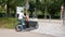 Unique bicycle with large container on the front is driven by a young woman in Munich 