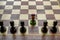 a unique chess pawn in color. leadership concept on a chessboard between other piece