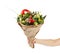 Unique colorful bouquet of vegetables and fruits in the hands of a girl on a white background