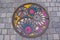 Unique and colorful manhole cover in the street of Matsumoto city