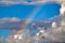 Unique and colorful rainbow in the clouds on a sunny Maui day.